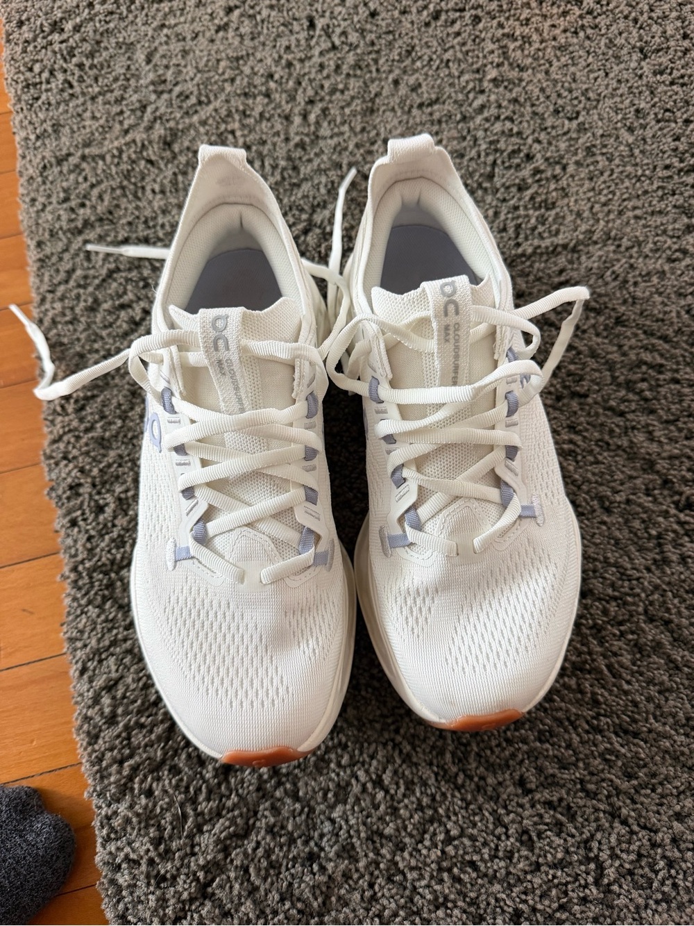 On Running Women's White Athletic Lace-Up Sneakers with Orange Toe Accent